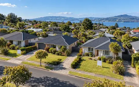 Aerial view of a New Zealand suburban street with similar homes